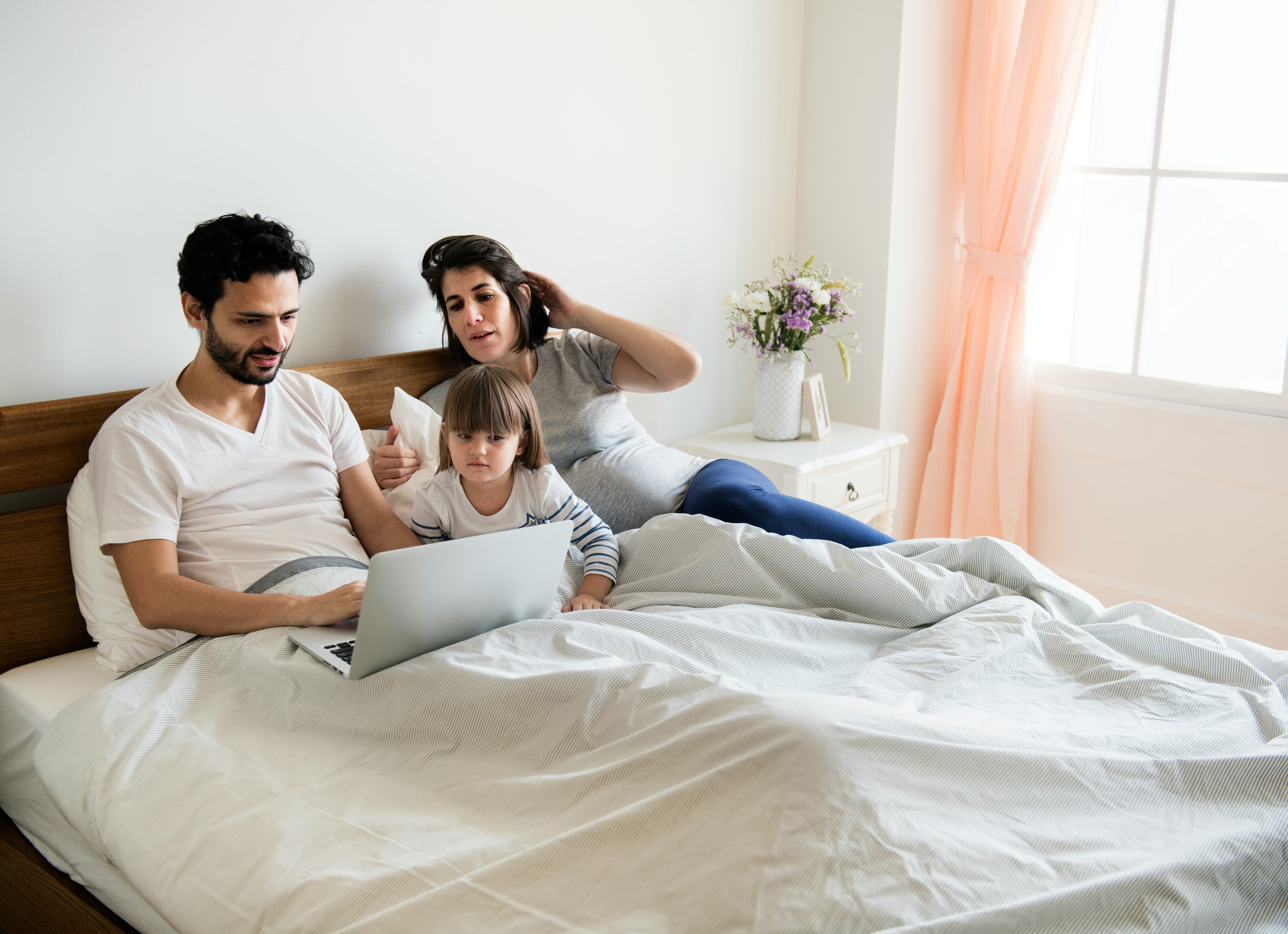 A family gathered around a laptop.